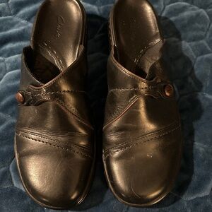 Clarks Black Leather Mules with Button Accent